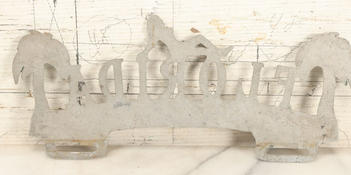 Lot 036 - Vintage Cast Aluminum Florida "Land Of Sunshine" License Plate Topper With Beach Babe In Bikini, Remnants Of Red And Green Paint