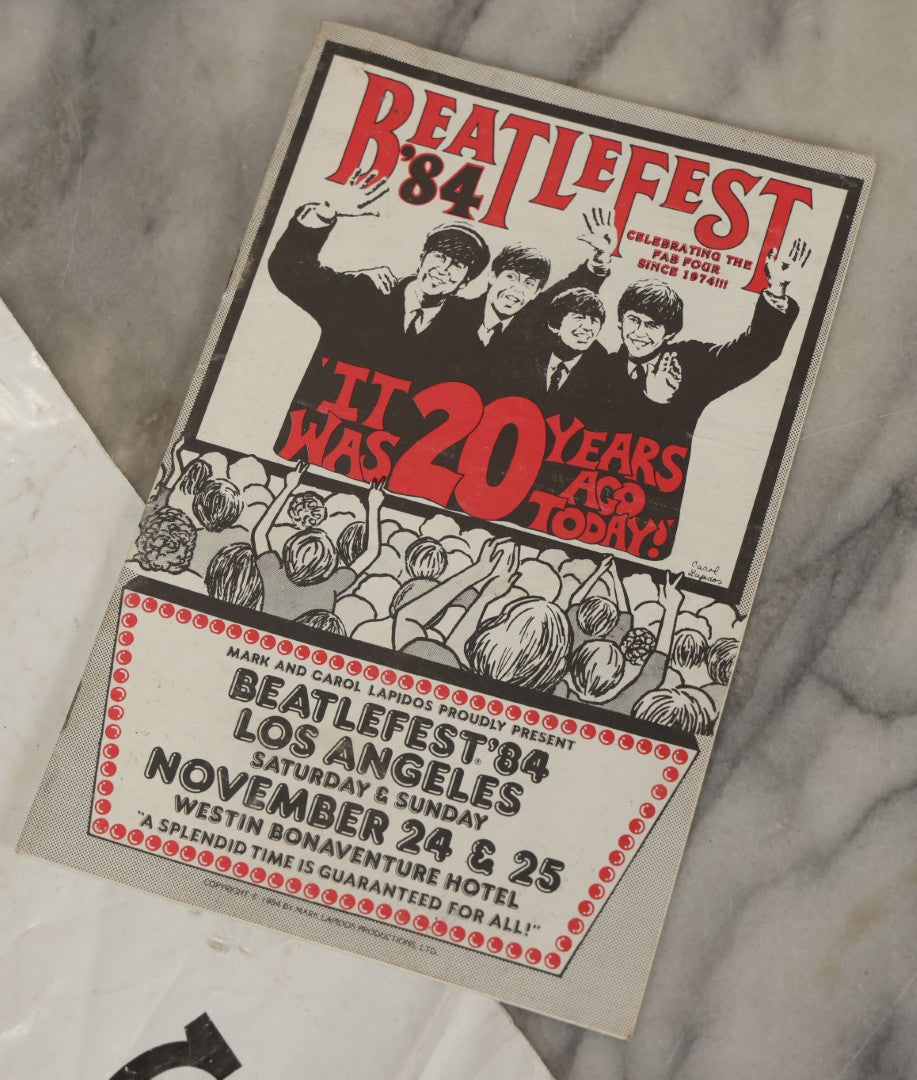 Lot 041 - Vintage "The Beatles" Band Collectibles Three Piece Grouping Including Plastic "We Love The Beatles" Shopping Bag, "The Compleat Beatles" Laserdisc, And Beatlefest 1984 Program