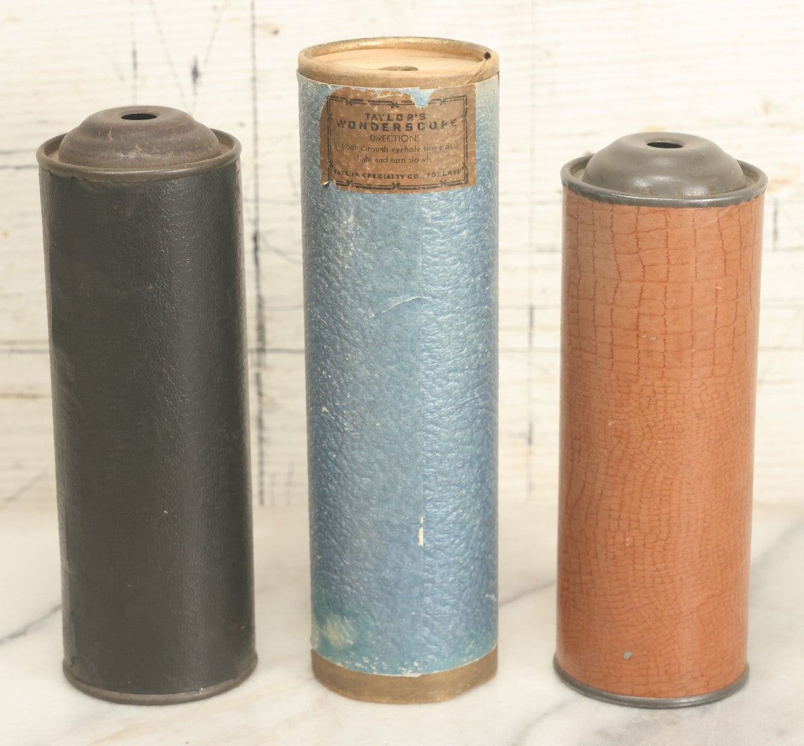 Lot 055 - Grouping Of Three Antique Leatherette Wrapped Kaleidoscopes, Including One With Paper Label, "Taylor's Wonderscope" By Taylor Specialty Co., Toronto, Canada