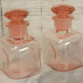 Lot 065 - Pair Of Antique Pink Depression Glass Etched Vanity Bathroom Jars With Stoppers, Alcohol And Mouthwash, 4-3/8" Height Each