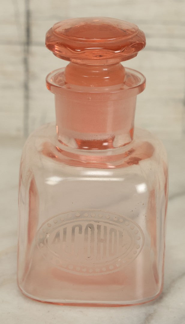 Lot 065 - Pair Of Antique Pink Depression Glass Etched Vanity Bathroom Jars With Stoppers, Alcohol And Mouthwash, 4-3/8" Height Each