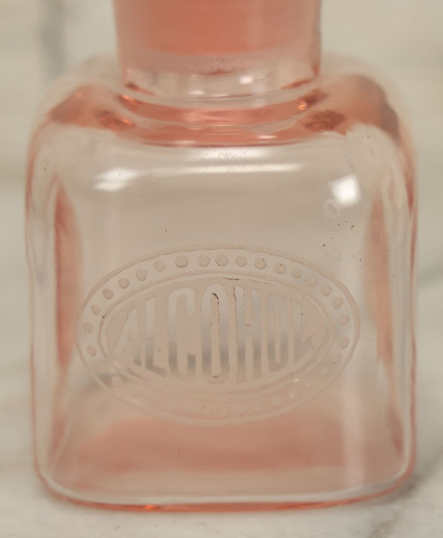 Lot 065 - Pair Of Antique Pink Depression Glass Etched Vanity Bathroom Jars With Stoppers, Alcohol And Mouthwash, 4-3/8" Height Each