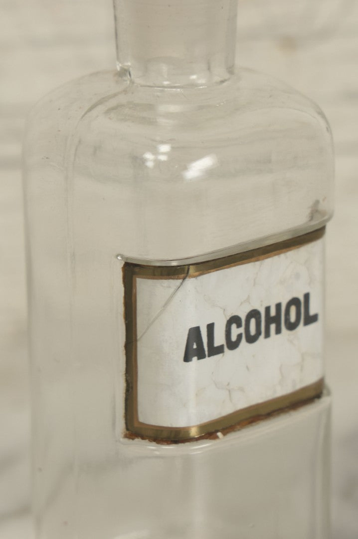 Lot 066 - Antique Whitall And Tatum Co. Glass Alcohol Apothecary Bottle Jar With Reverse Painted Glass Label, Note Chip To Lip Of Bottle, Crack In Label, 7" Height