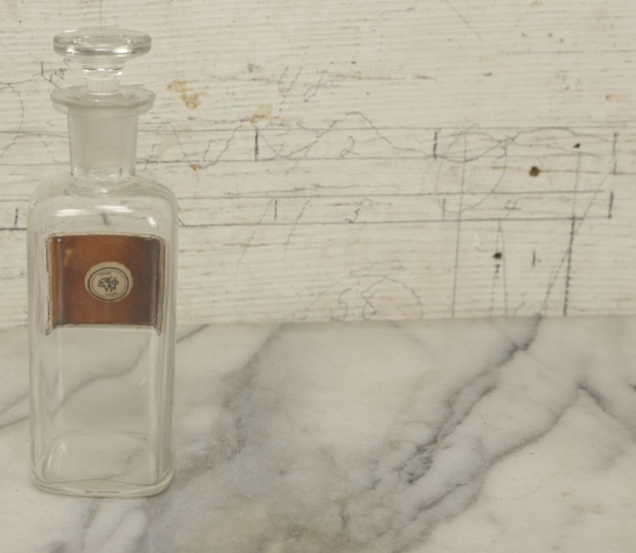 Lot 066 - Antique Whitall And Tatum Co. Glass Alcohol Apothecary Bottle Jar With Reverse Painted Glass Label, Note Chip To Lip Of Bottle, Crack In Label, 7" Height