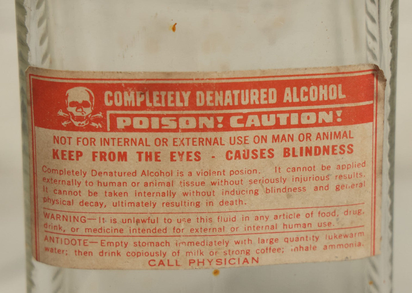 Lot 069 - Vintage Glass Pharmacy Jar Jug Bottle With Applied Paper Label, Completely Denatured Alcohol, Poison: Caution! With Skull And Crossbones, 7-5/8" Height