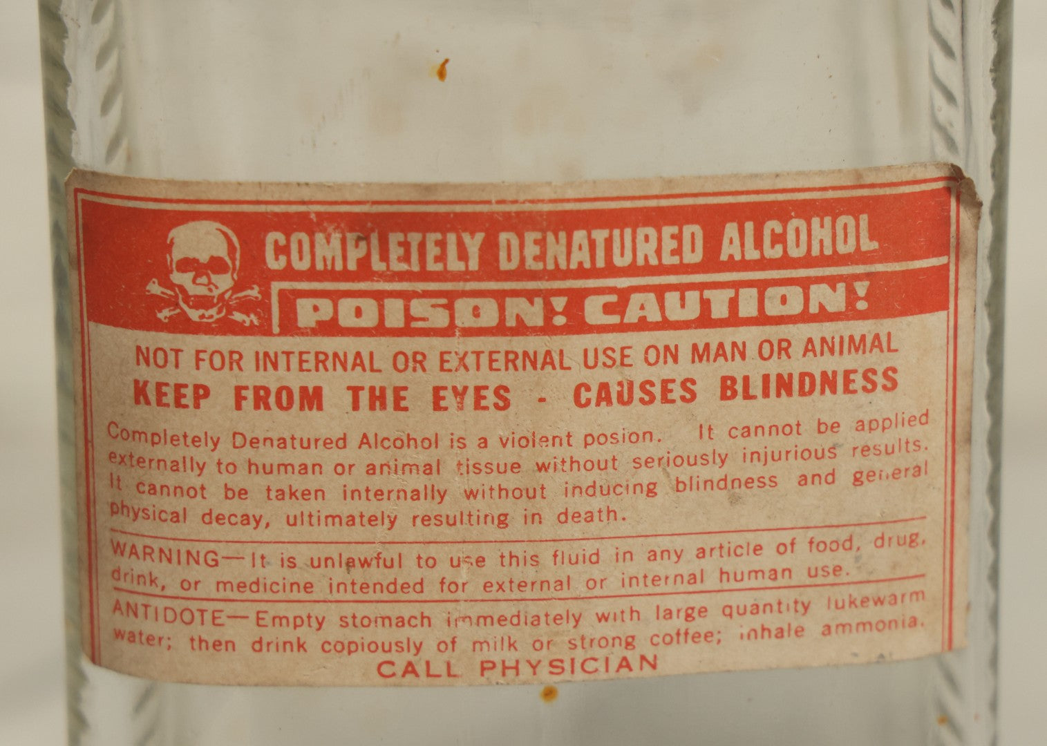 Lot 069 - Vintage Glass Pharmacy Jar Jug Bottle With Applied Paper Label, Completely Denatured Alcohol, Poison: Caution! With Skull And Crossbones, 7-5/8" Height