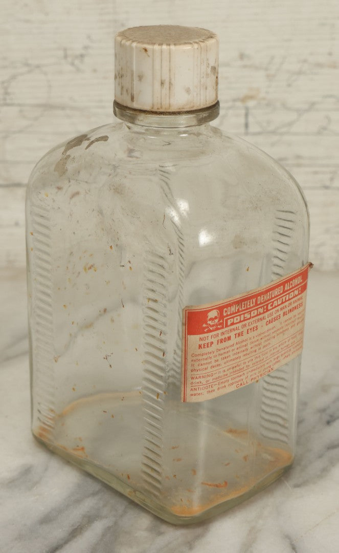 Lot 069 - Vintage Glass Pharmacy Jar Jug Bottle With Applied Paper Label, Completely Denatured Alcohol, Poison: Caution! With Skull And Crossbones, 7-5/8" Height