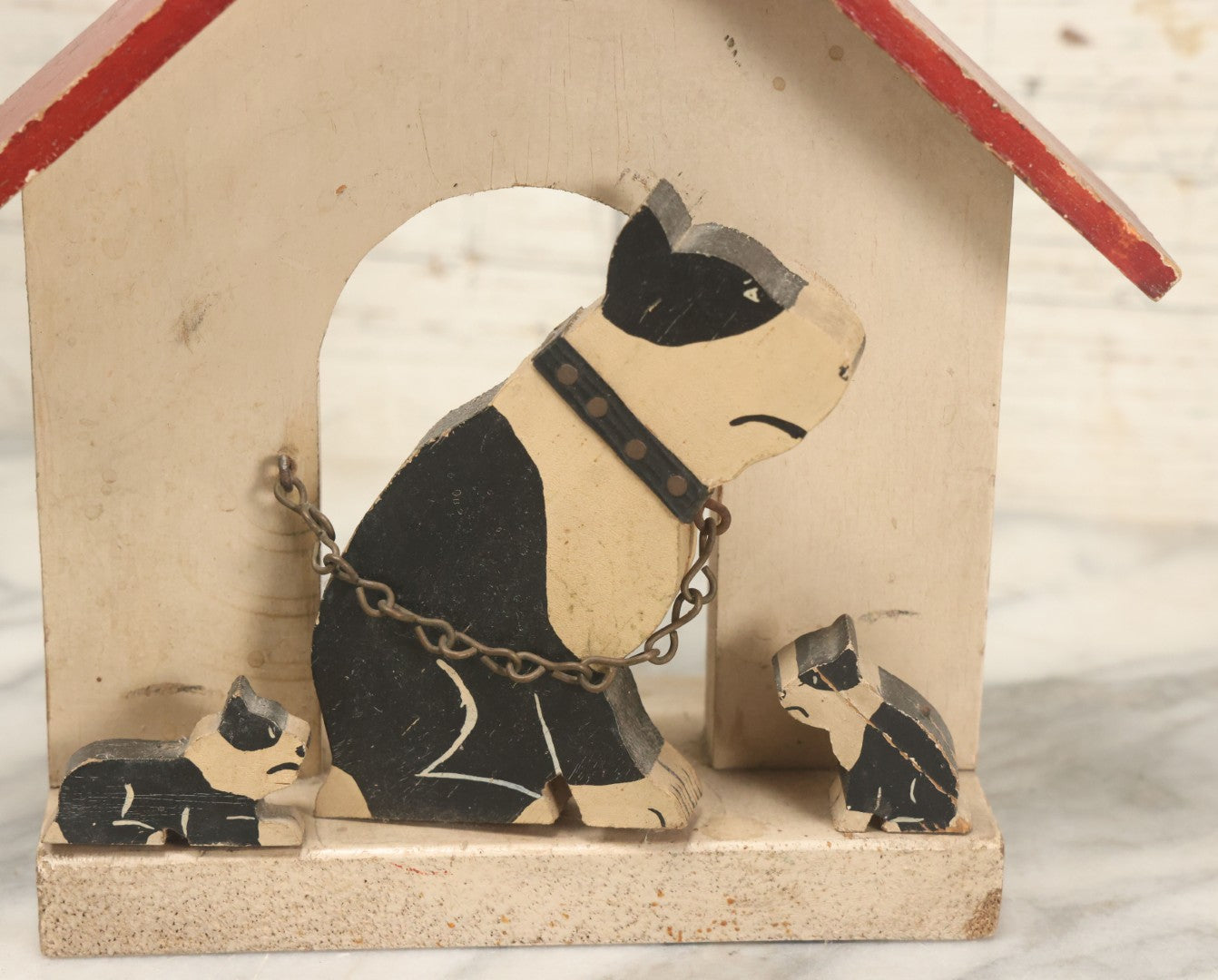 Lot 024 - Vintage Folk Art Boston Terrier Hand Painted, Hand Cut Wooden Door Stop With White House, Red Roof, Dog With Two Puppies