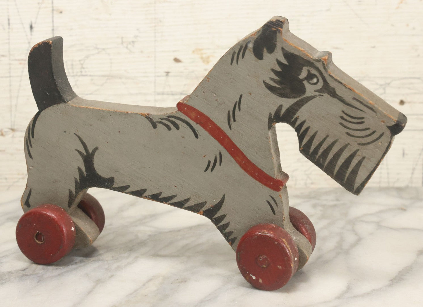 Lot 027 - Vintage Folk Art Hand Painted, Hand Cut Wooden Scottie Dog Rolling Toy