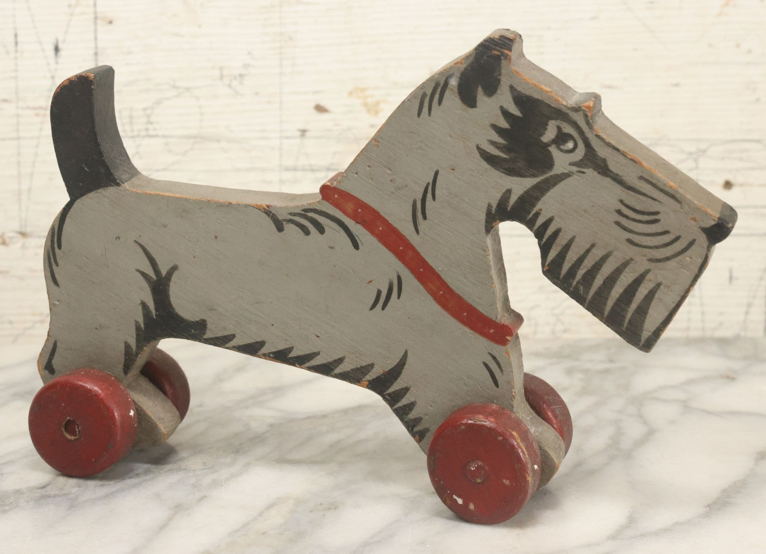 Lot 027 - Vintage Folk Art Hand Painted, Hand Cut Wooden Scottie Dog Rolling Toy