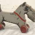 Lot 027 - Vintage Folk Art Hand Painted, Hand Cut Wooden Scottie Dog Rolling Toy