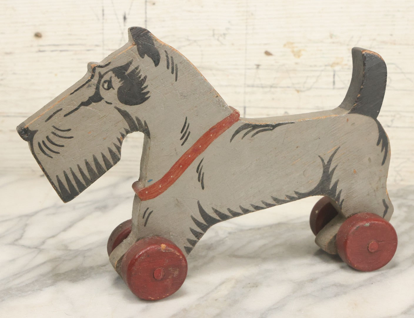Lot 027 - Vintage Folk Art Hand Painted, Hand Cut Wooden Scottie Dog Rolling Toy