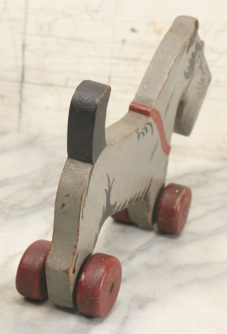 Lot 027 - Vintage Folk Art Hand Painted, Hand Cut Wooden Scottie Dog Rolling Toy