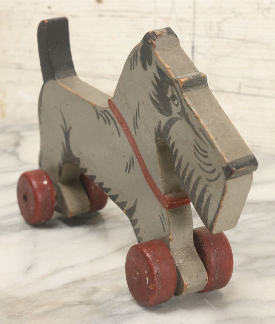 Lot 027 - Vintage Folk Art Hand Painted, Hand Cut Wooden Scottie Dog Rolling Toy