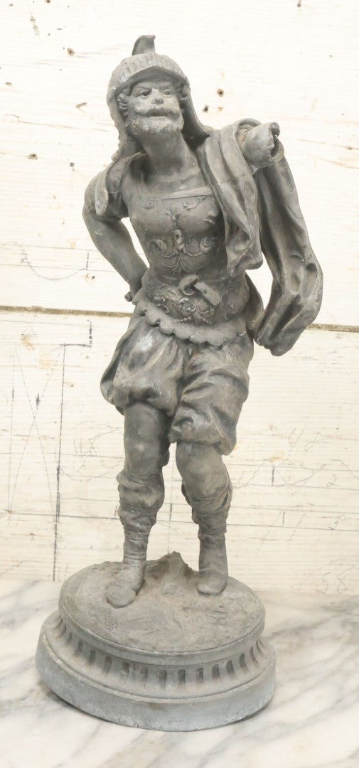 Lot 035 - Antique Spelter Metal Soldier Statue, Wearing Armor And Helmet, Note Missing Arm, Damaged / Warped Based, Overall Poor Condition, 16-1/2" Height