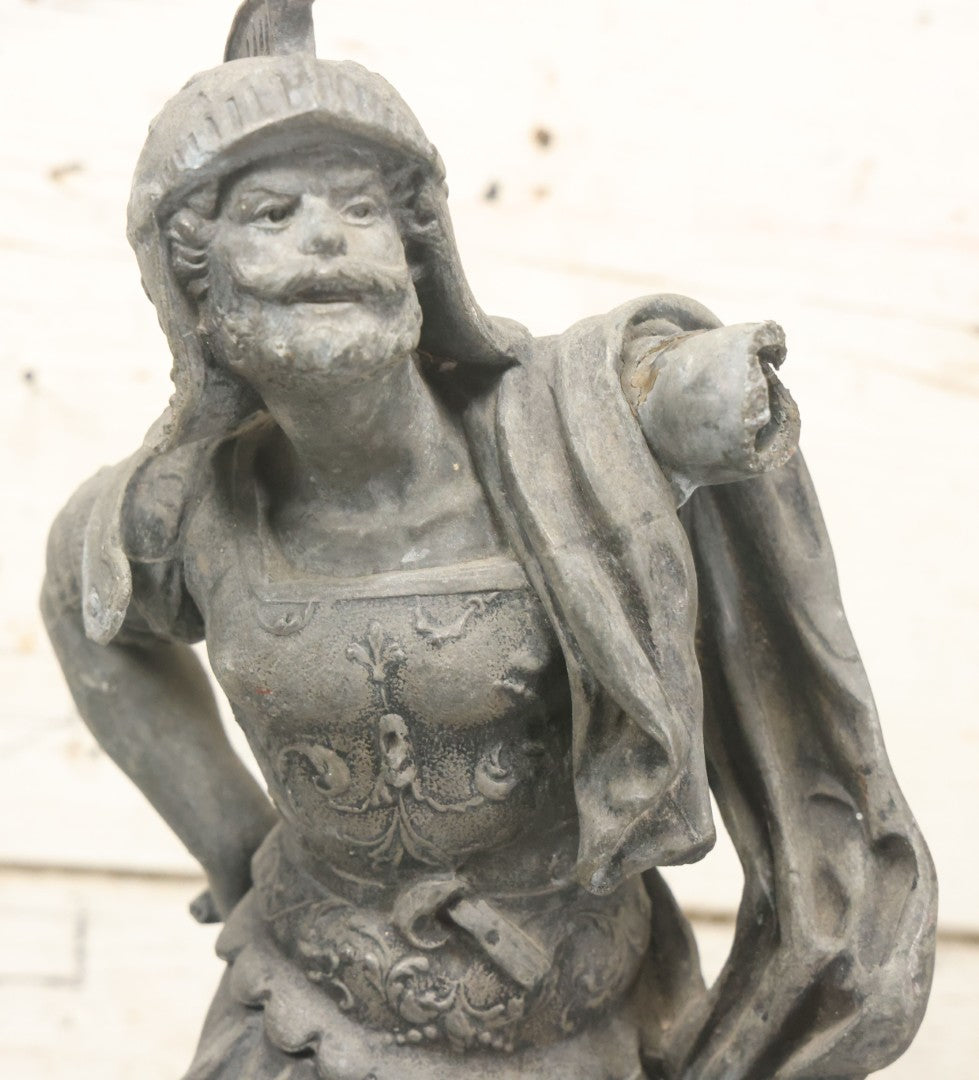 Lot 035 - Antique Spelter Metal Soldier Statue, Wearing Armor And Helmet, Note Missing Arm, Damaged / Warped Based, Overall Poor Condition, 16-1/2" Height