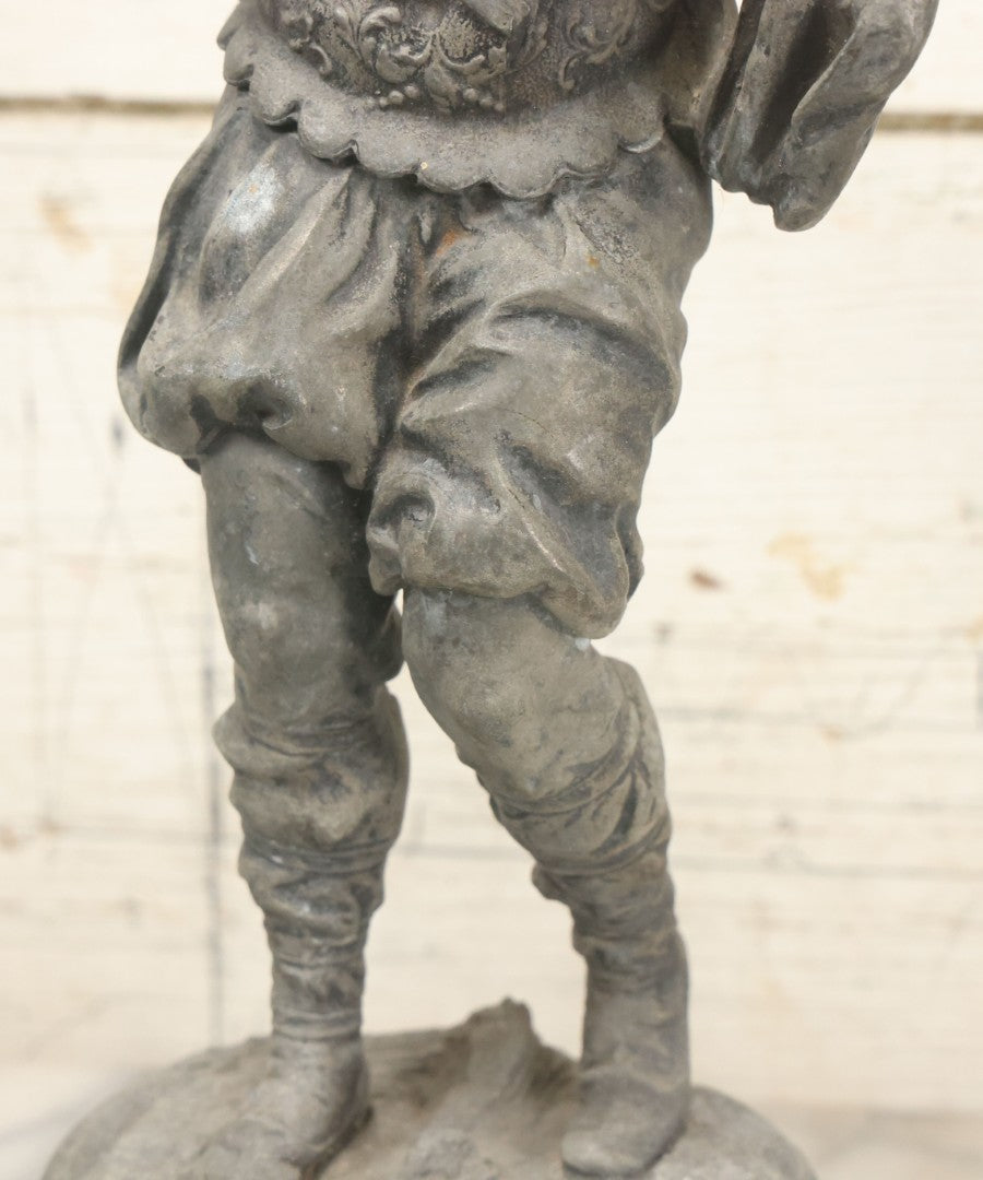 Lot 035 - Antique Spelter Metal Soldier Statue, Wearing Armor And Helmet, Note Missing Arm, Damaged / Warped Based, Overall Poor Condition, 16-1/2" Height