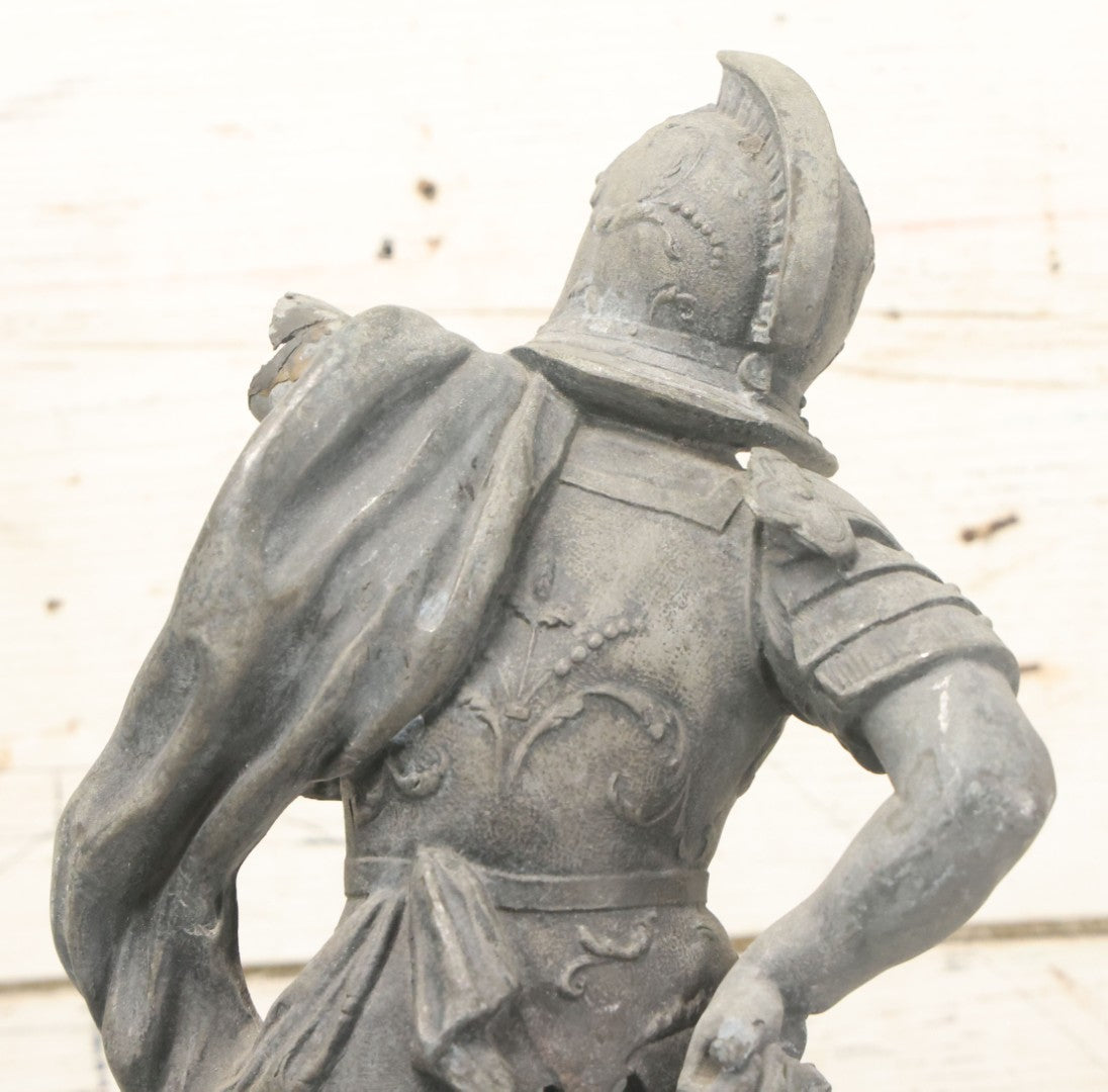 Lot 035 - Antique Spelter Metal Soldier Statue, Wearing Armor And Helmet, Note Missing Arm, Damaged / Warped Based, Overall Poor Condition, 16-1/2" Height
