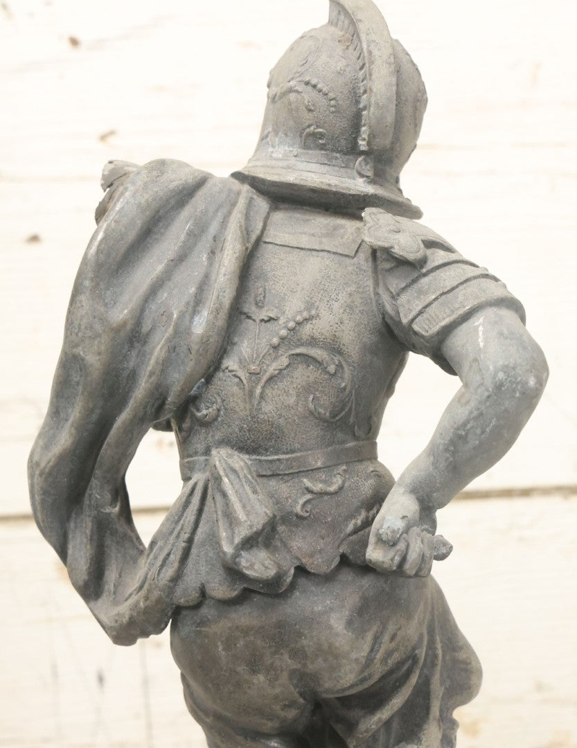 Lot 035 - Antique Spelter Metal Soldier Statue, Wearing Armor And Helmet, Note Missing Arm, Damaged / Warped Based, Overall Poor Condition, 16-1/2" Height