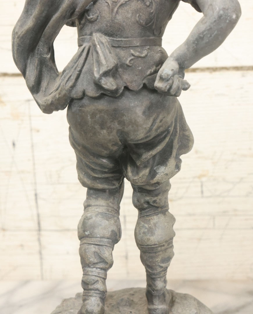 Lot 035 - Antique Spelter Metal Soldier Statue, Wearing Armor And Helmet, Note Missing Arm, Damaged / Warped Based, Overall Poor Condition, 16-1/2" Height