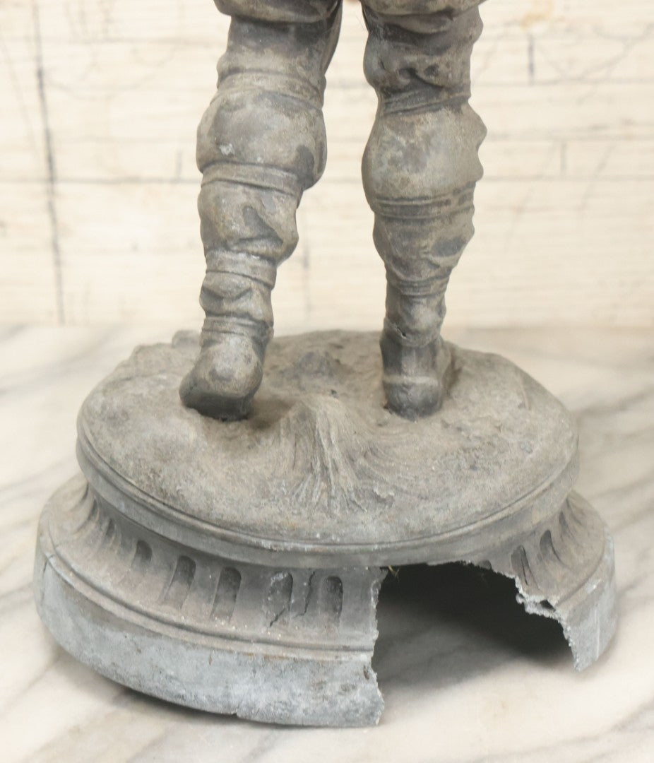 Lot 035 - Antique Spelter Metal Soldier Statue, Wearing Armor And Helmet, Note Missing Arm, Damaged / Warped Based, Overall Poor Condition, 16-1/2" Height