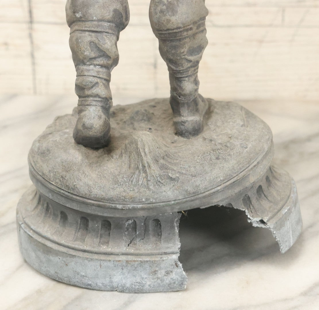 Lot 035 - Antique Spelter Metal Soldier Statue, Wearing Armor And Helmet, Note Missing Arm, Damaged / Warped Based, Overall Poor Condition, 16-1/2" Height