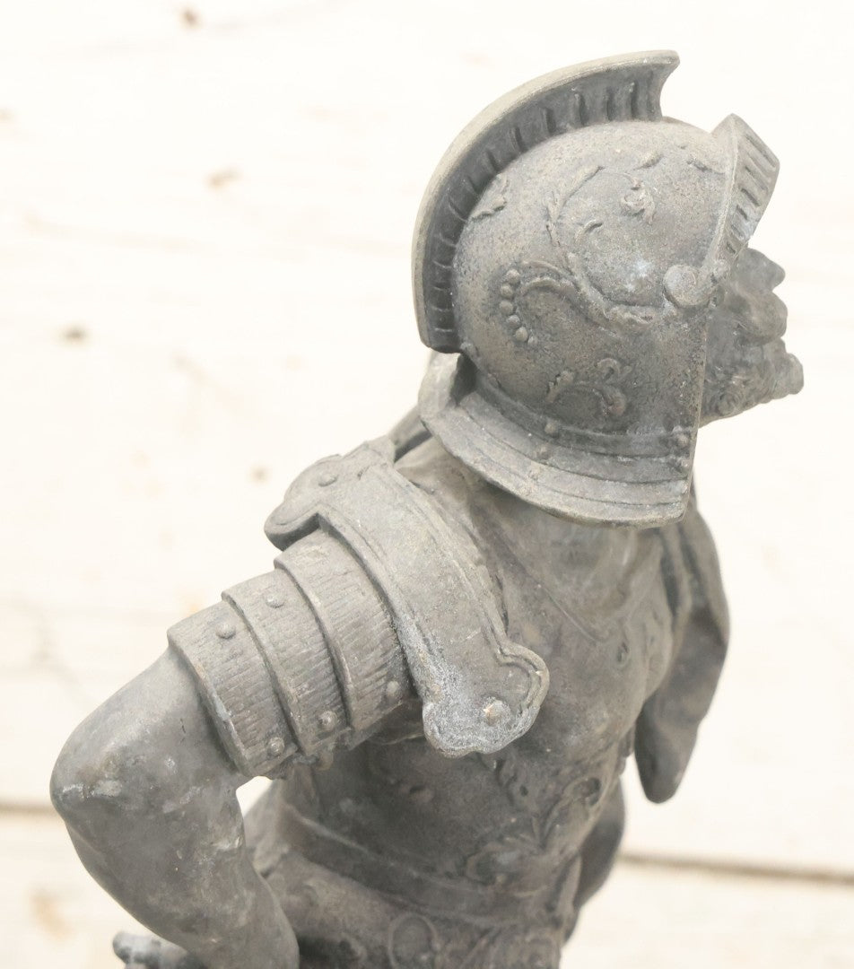 Lot 035 - Antique Spelter Metal Soldier Statue, Wearing Armor And Helmet, Note Missing Arm, Damaged / Warped Based, Overall Poor Condition, 16-1/2" Height