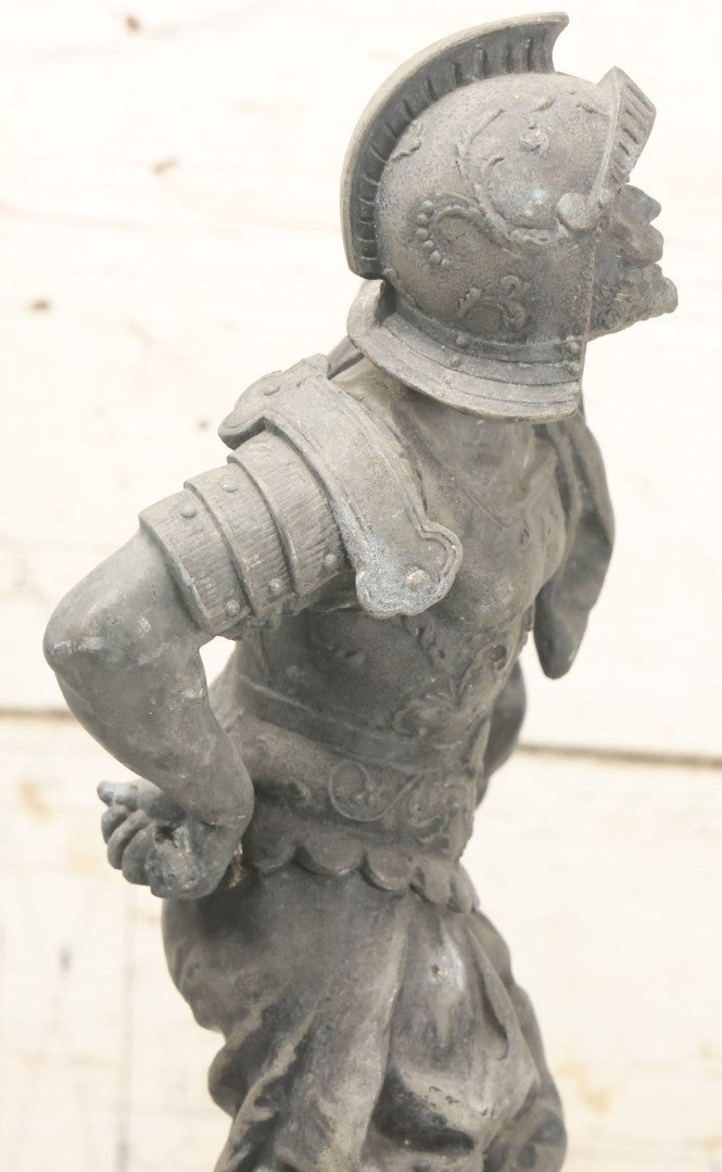Lot 035 - Antique Spelter Metal Soldier Statue, Wearing Armor And Helmet, Note Missing Arm, Damaged / Warped Based, Overall Poor Condition, 16-1/2" Height