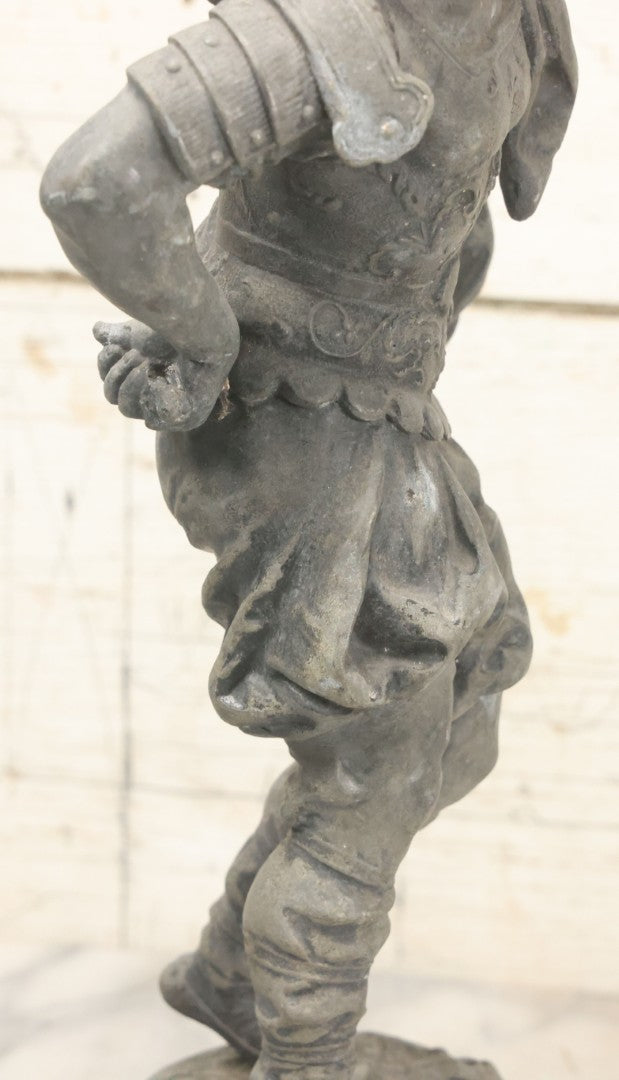 Lot 035 - Antique Spelter Metal Soldier Statue, Wearing Armor And Helmet, Note Missing Arm, Damaged / Warped Based, Overall Poor Condition, 16-1/2" Height