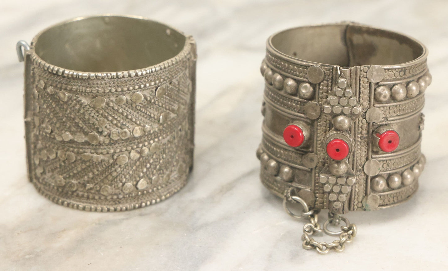 Lot 038 - Pair Of Ornate Middle Eastern Metal Cuff Bracelets, One With Red Beads