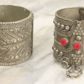 Lot 038 - Pair Of Ornate Middle Eastern Metal Cuff Bracelets, One With Red Beads