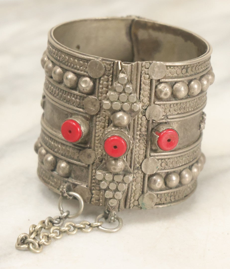 Lot 038 - Pair Of Ornate Middle Eastern Metal Cuff Bracelets, One With Red Beads