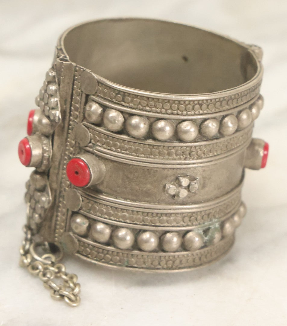 Lot 038 - Pair Of Ornate Middle Eastern Metal Cuff Bracelets, One With Red Beads