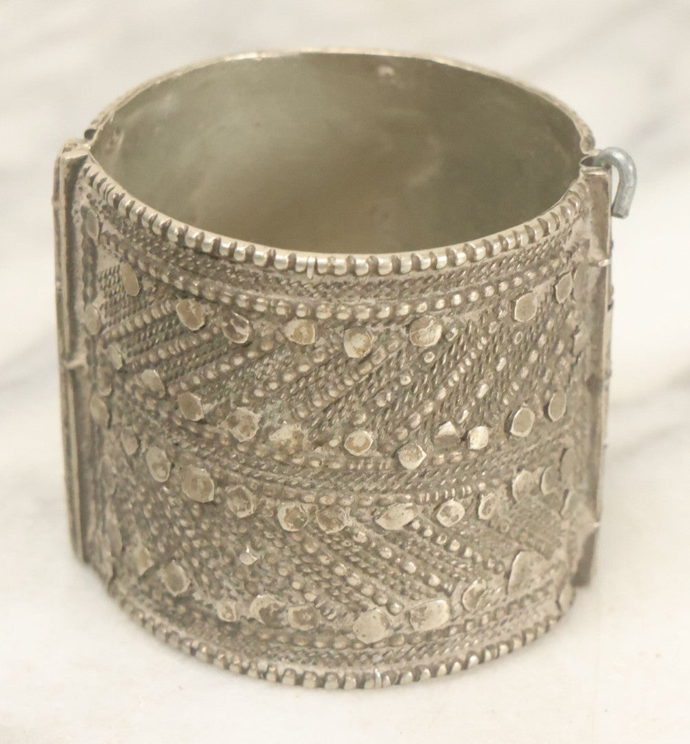 Lot 038 - Pair Of Ornate Middle Eastern Metal Cuff Bracelets, One With Red Beads