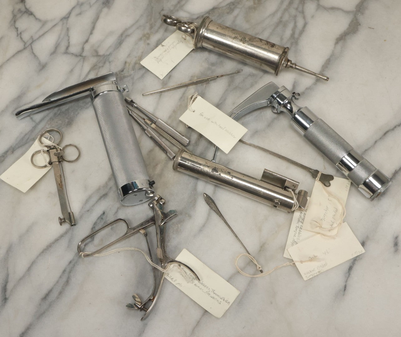 Lot 051 - Grouping Of Ten Vintage Medical Devices, Including Spection Devices, Irrigation Syringe, Etc., With Paper Identification Tags