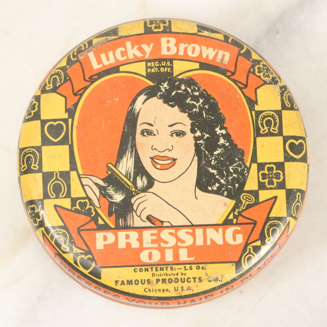 Lot 075 - Vintage Lucky Brown Pressing Oil Hair Product Tin, Distributed By Famous Products Co., Chicago