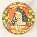 Lot 075 - Vintage Lucky Brown Pressing Oil Hair Product Tin, Distributed By Famous Products Co., Chicago
