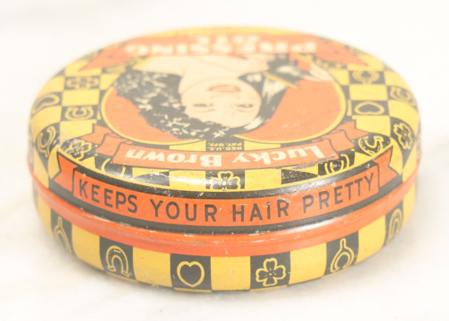 Lot 075 - Vintage Lucky Brown Pressing Oil Hair Product Tin, Distributed By Famous Products Co., Chicago