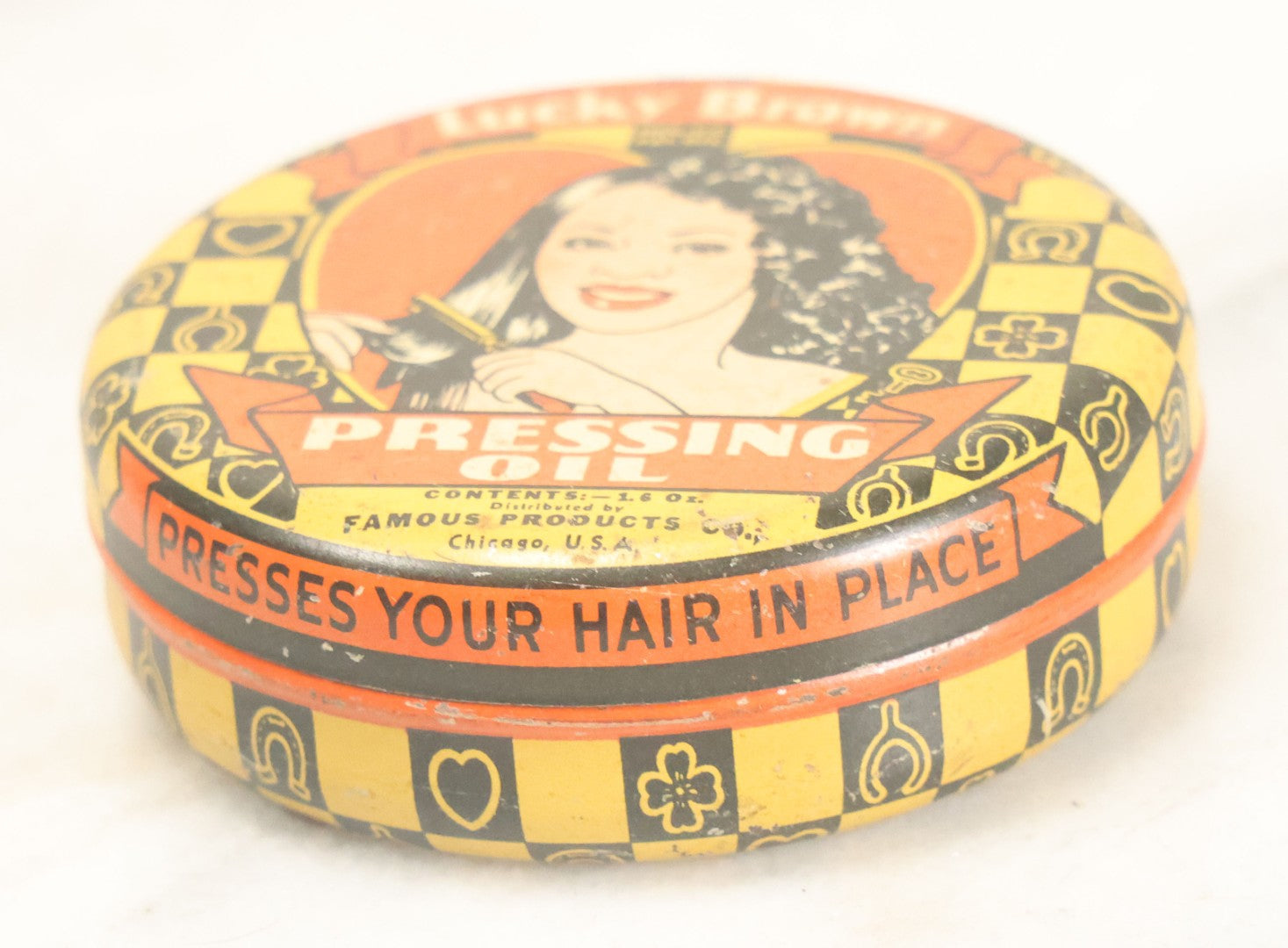 Lot 075 - Vintage Lucky Brown Pressing Oil Hair Product Tin, Distributed By Famous Products Co., Chicago