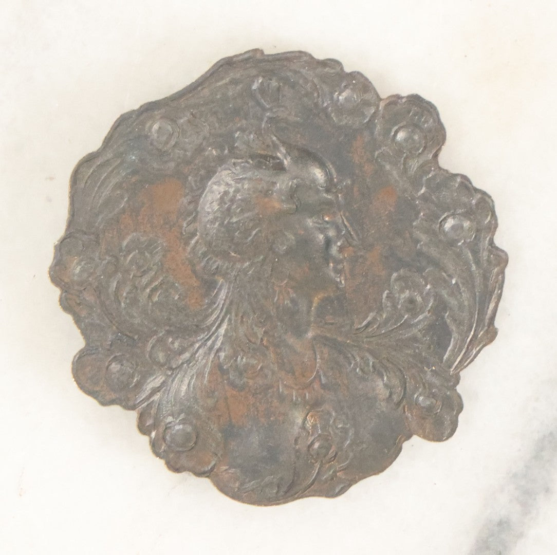 Lot 076 - Antique Art Nouveau Metal Medallion With Woman In Elaborate Peacock Or Swan Headdress, As Found