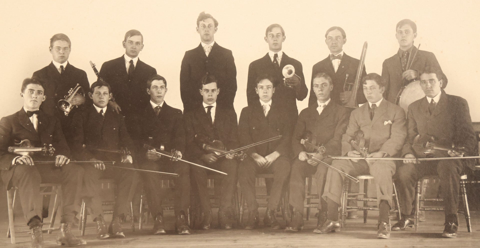 Lot 089 - Pair Of Antique Boarded Photographs Of A Band Posing With Their Instruments, Including String, Drums, And Horns, 14" x 11"