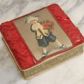 Lot 085 - Antique Paper Board Candy Box With Tufted Red Fabric, Blue Boy With Flowers Graphic On Cover