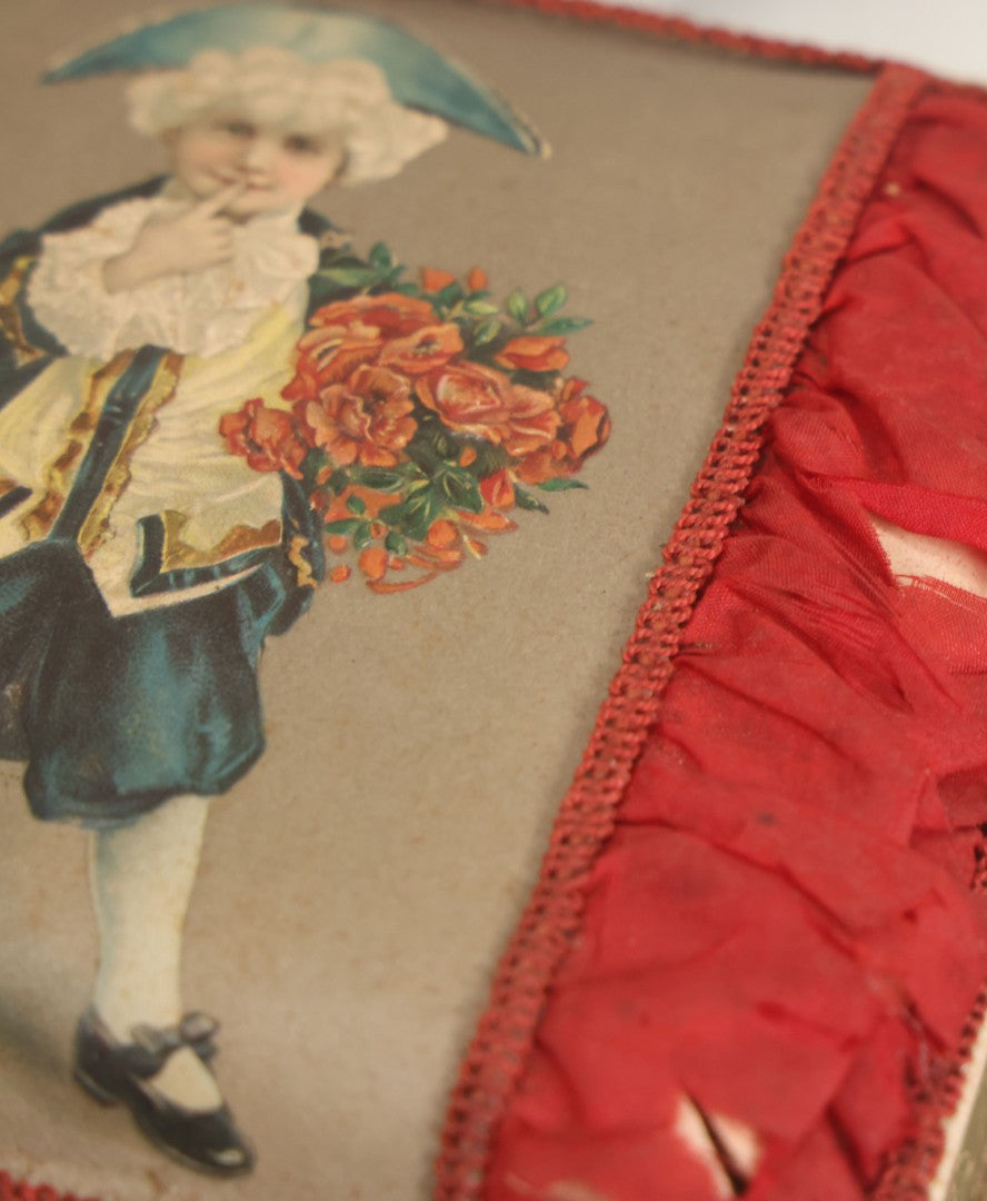 Lot 085 - Antique Paper Board Candy Box With Tufted Red Fabric, Blue Boy With Flowers Graphic On Cover