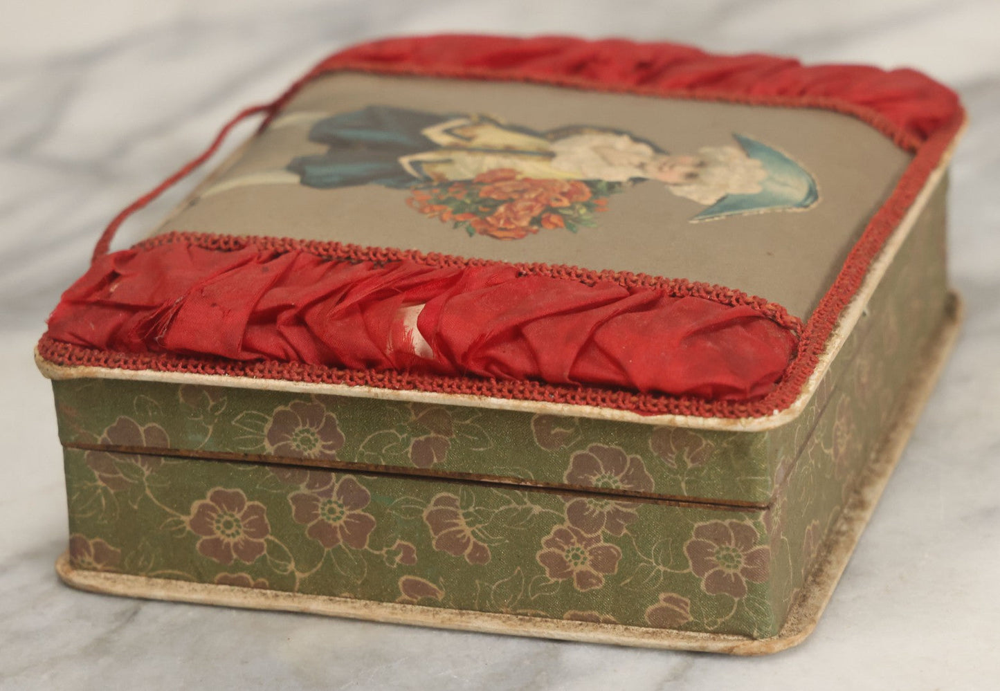 Lot 085 - Antique Paper Board Candy Box With Tufted Red Fabric, Blue Boy With Flowers Graphic On Cover