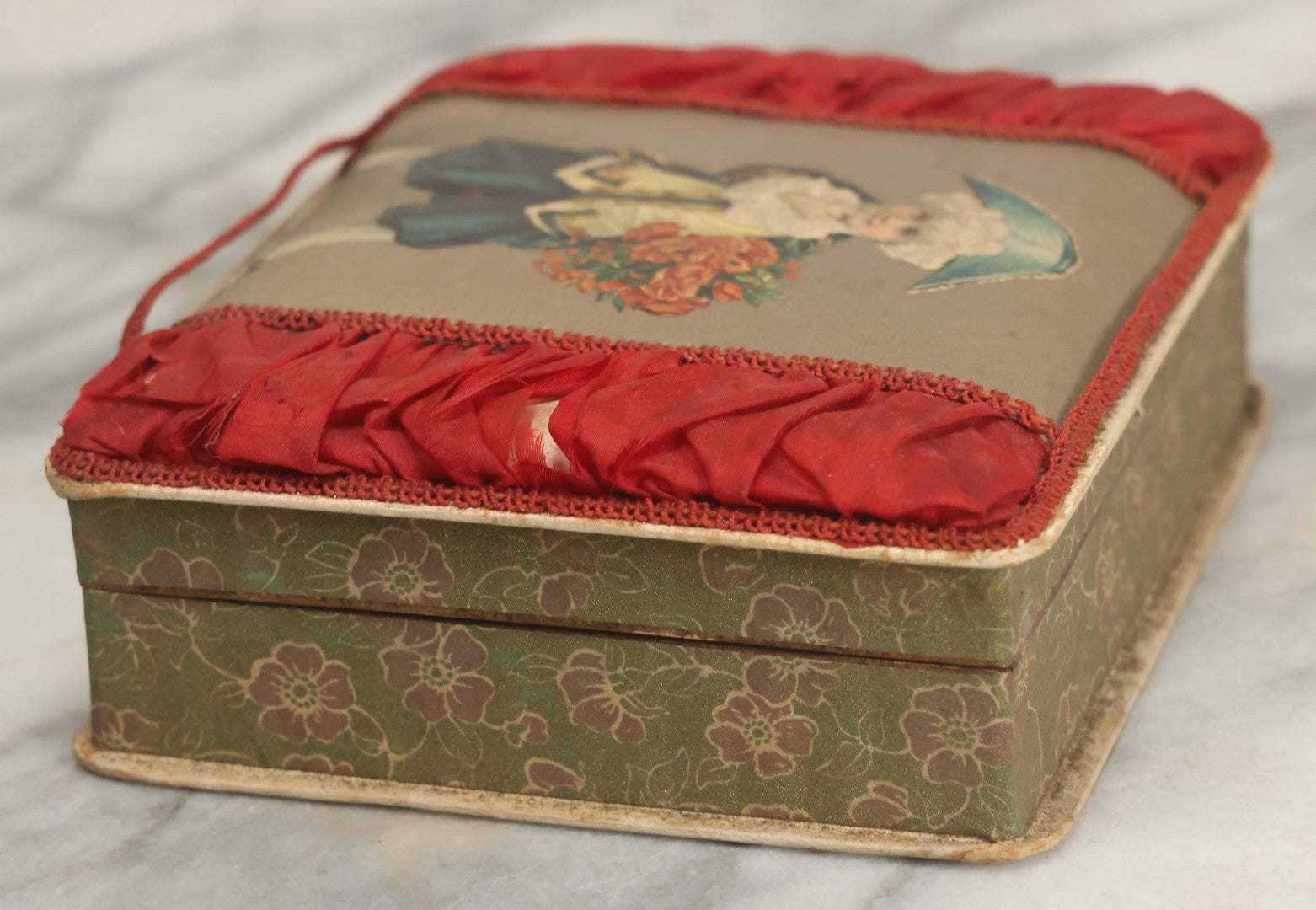 Lot 085 - Antique Paper Board Candy Box With Tufted Red Fabric, Blue Boy With Flowers Graphic On Cover