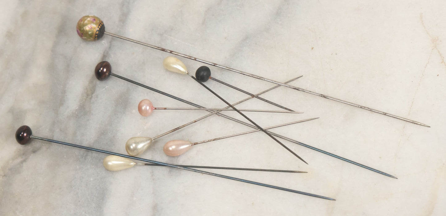 Lot 088 - Grouping Of Nine Vintage Hat Pins Including Pin With Painted Head With Purple Flowers, Mother Of Pearl Pin Heads, And More