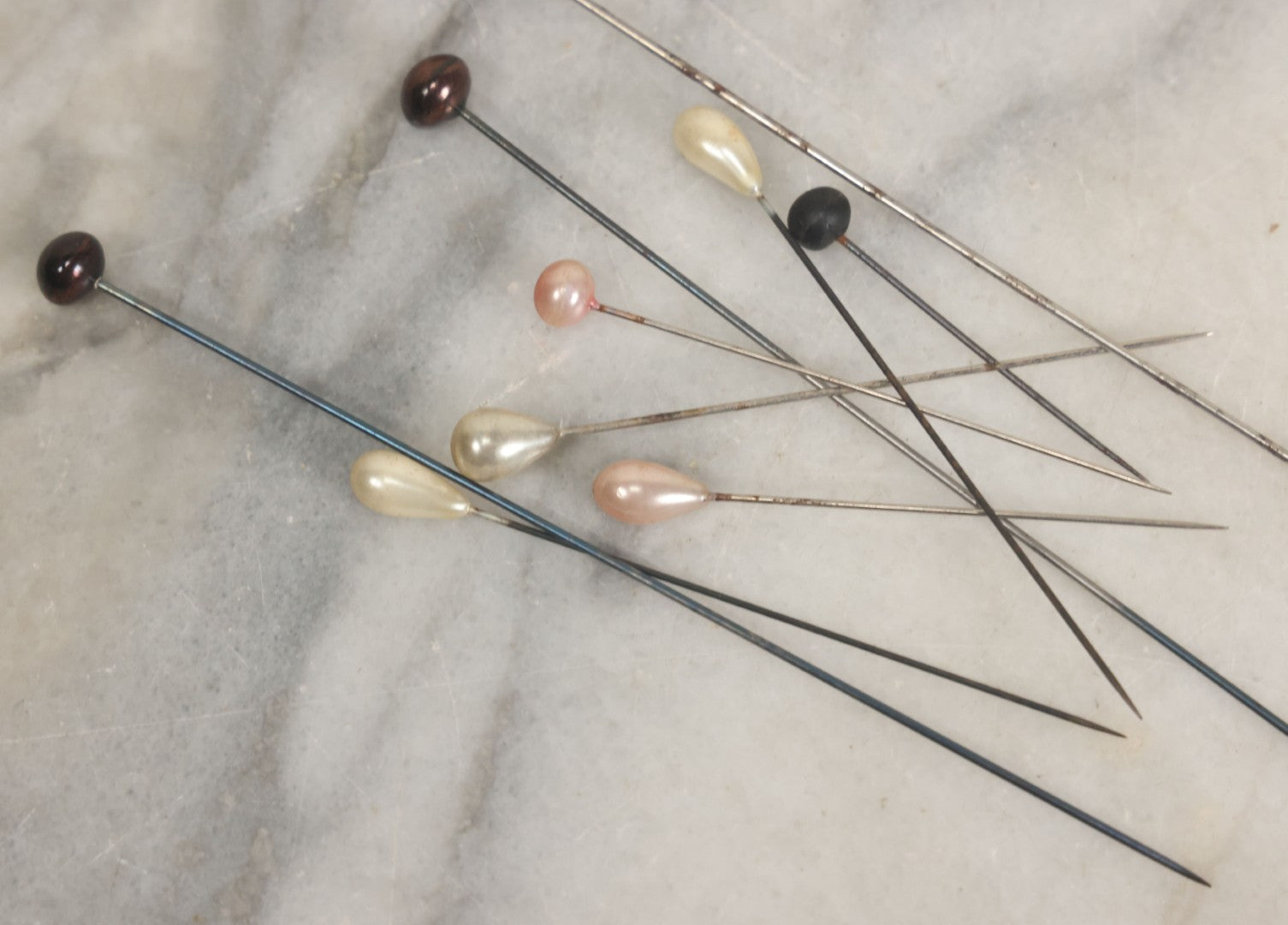 Lot 088 - Grouping Of Nine Vintage Hat Pins Including Pin With Painted Head With Purple Flowers, Mother Of Pearl Pin Heads, And More