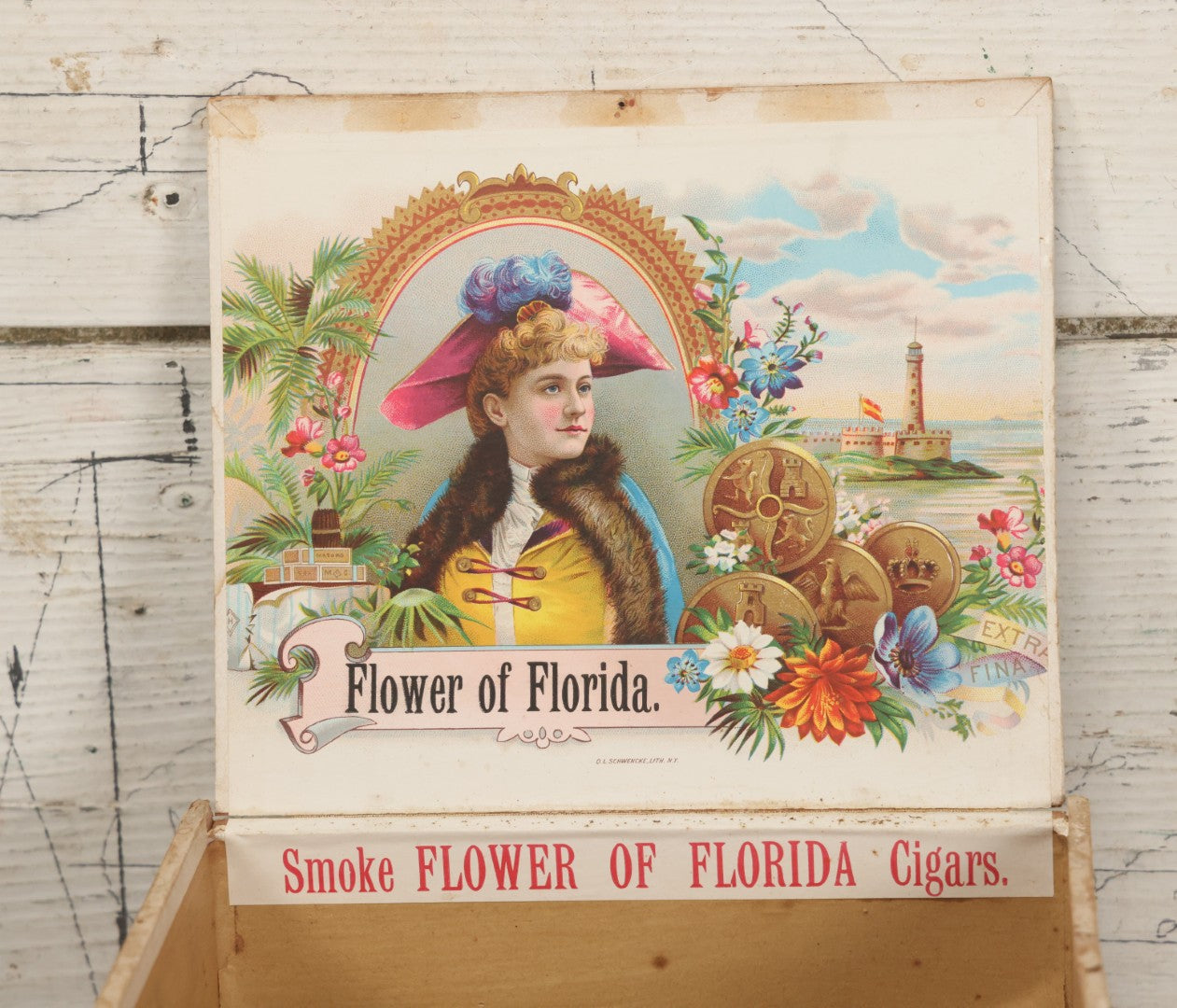 Lot 097 - Antique Wooden Cigar Box With Lithographed Label For Flower Of Florida Cigars, With Woman In Pink Hat & Lighthouse Graphics On External And Internal Labels, Paper Label From Milliken Tomlinson Company, Portland, Maine