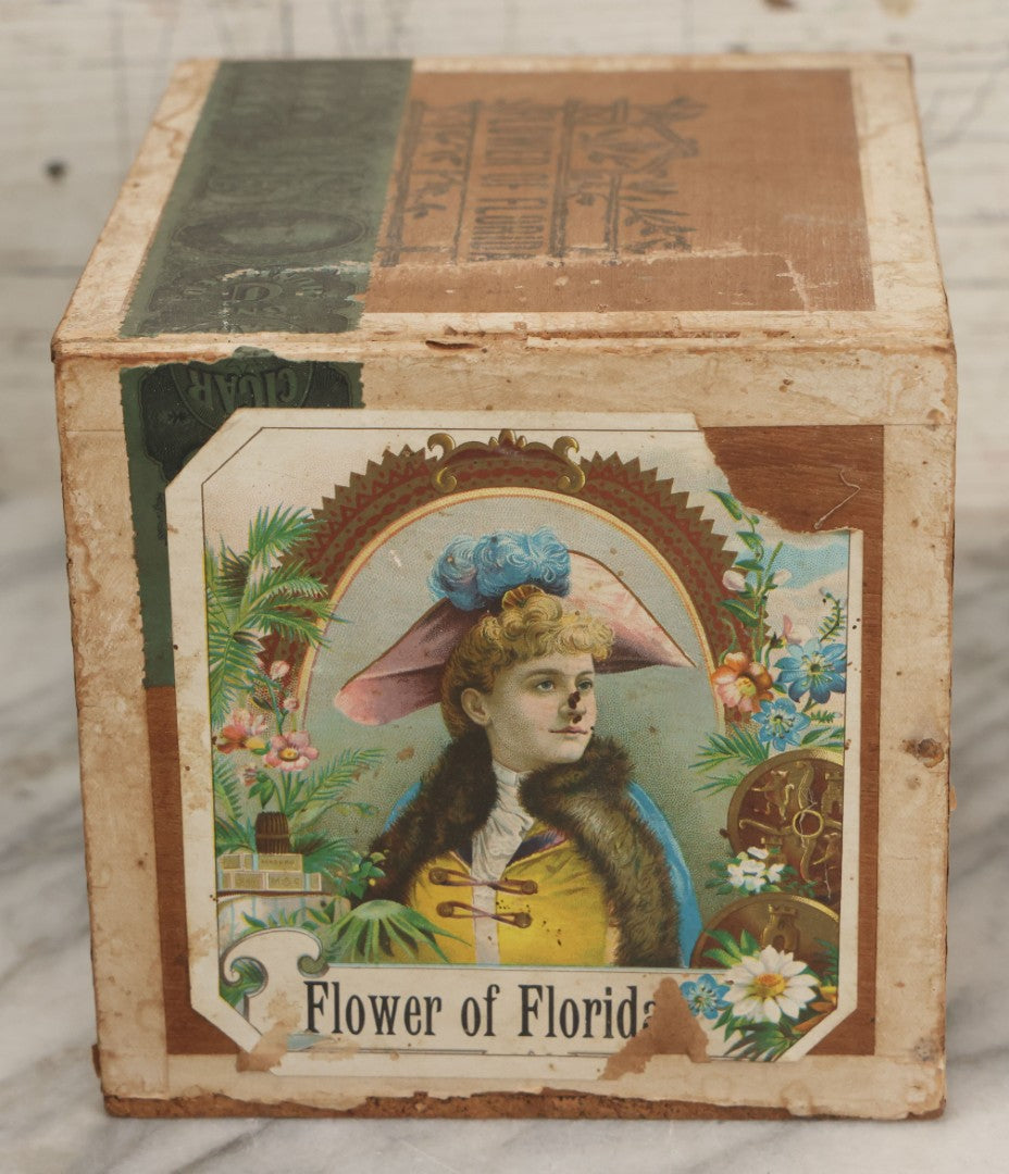 Lot 097 - Antique Wooden Cigar Box With Lithographed Label For Flower Of Florida Cigars, With Woman In Pink Hat & Lighthouse Graphics On External And Internal Labels, Paper Label From Milliken Tomlinson Company, Portland, Maine