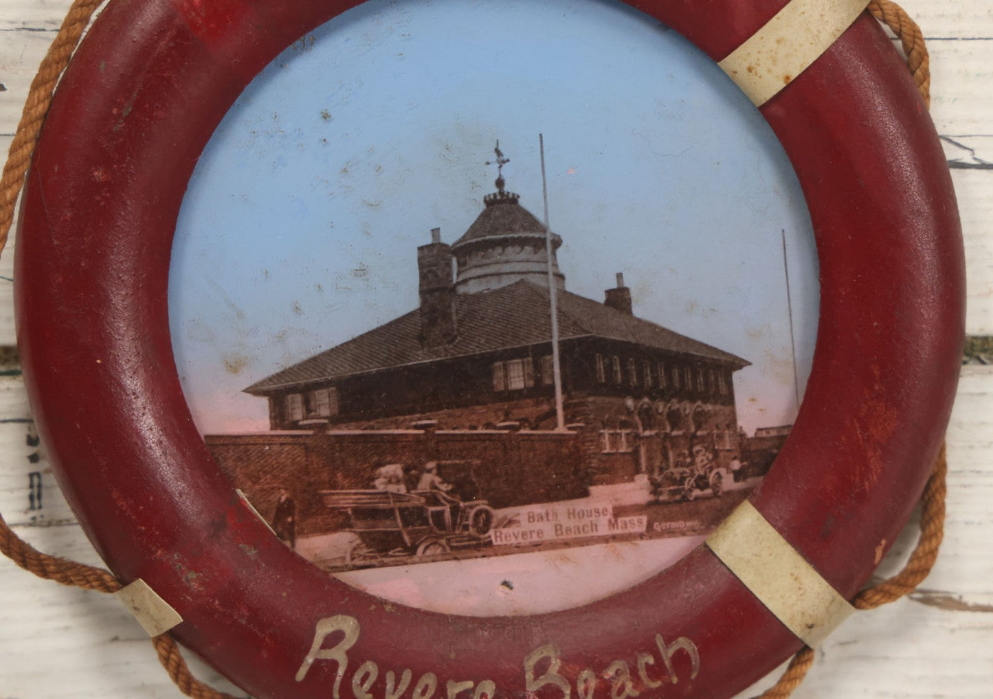 Lot 101 - Antique Souvenir Of Revere Beach, Massachusetts, With Photo Of Bath House And Automobile, In Hand Painted Life Preserver Frame With Rope Embellishments
